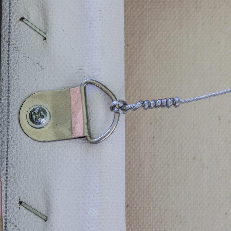 Close-up of the wire hanger attached to a canvas