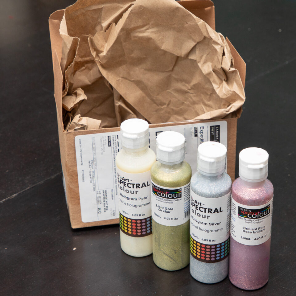 Containers of paint sit on a table