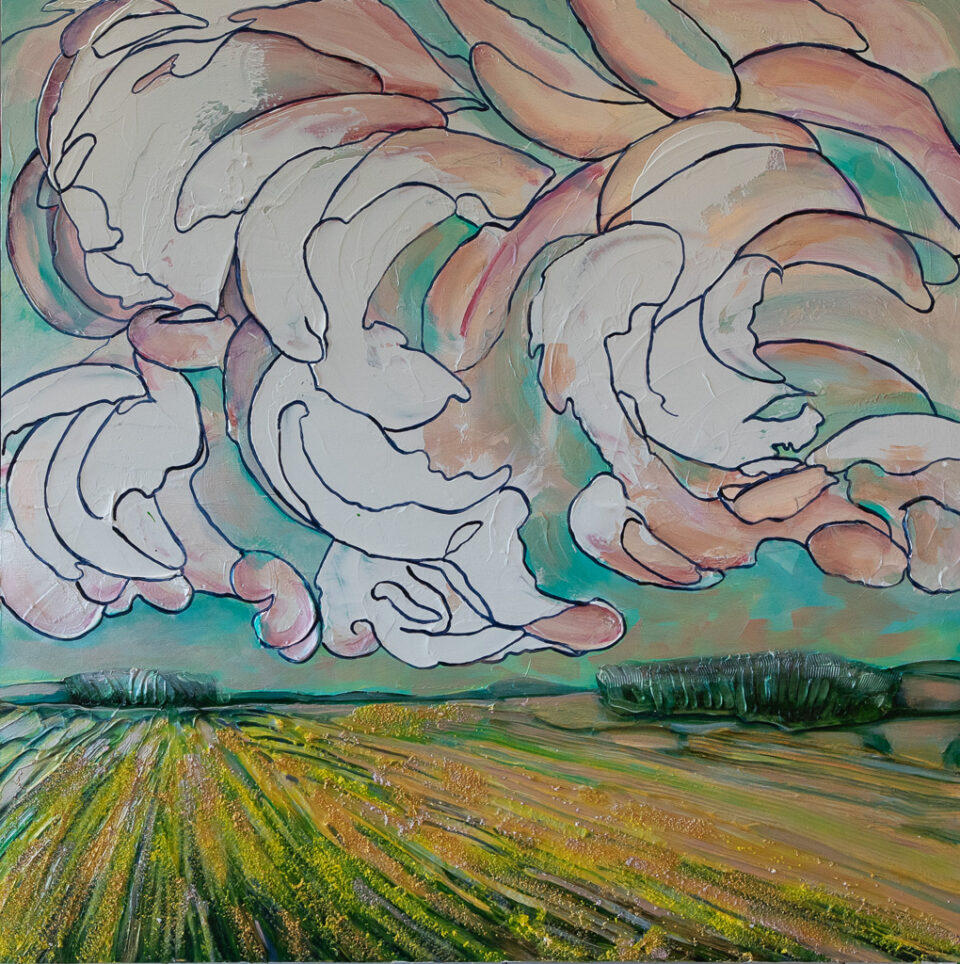 Swirling white and pink clouds fill an aqua sky over a bright yellow field of canola.